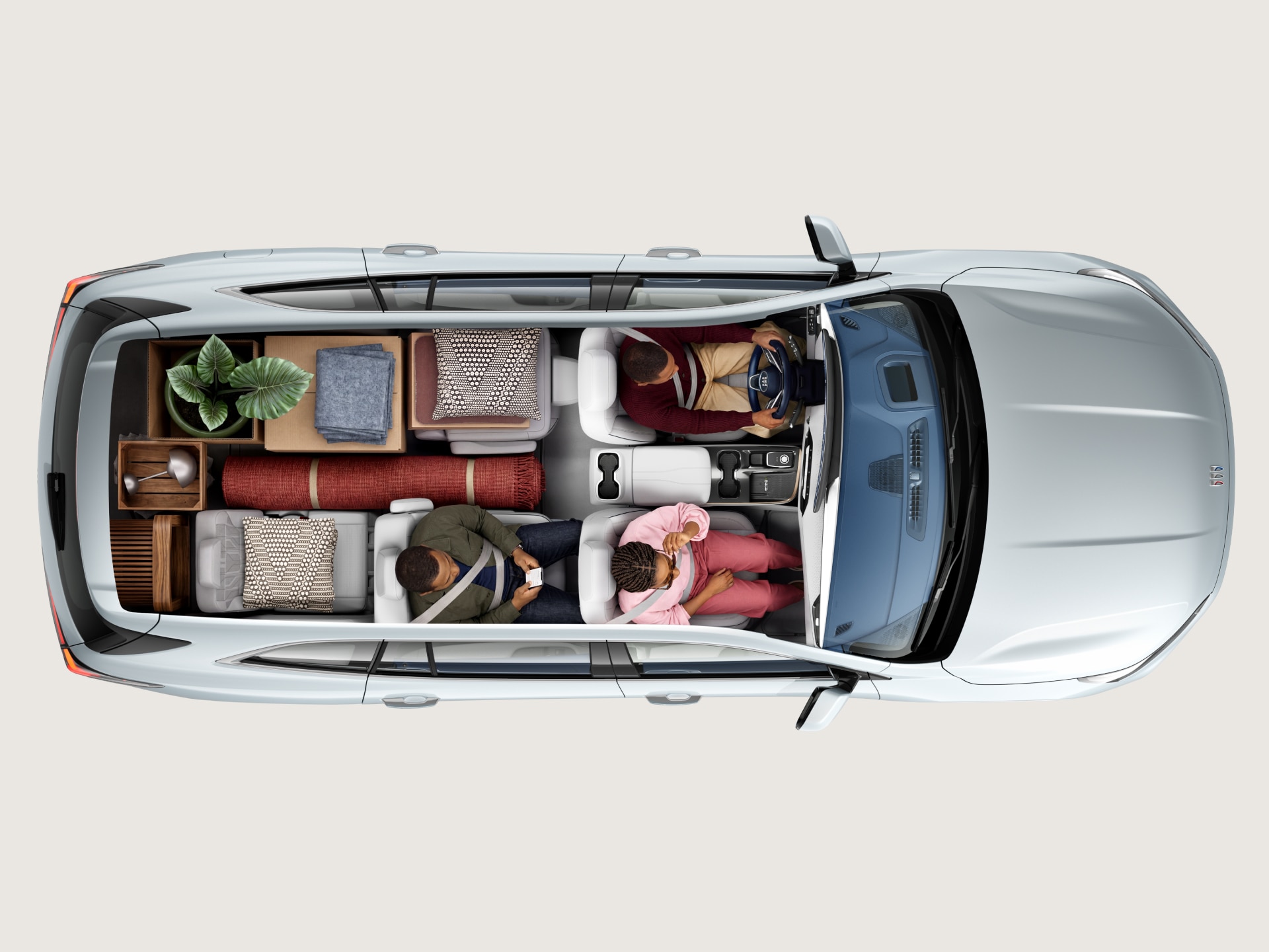 Overhead View of a White Buick SUV Interior with Four People and Various Cargo Items in the Trunk Space