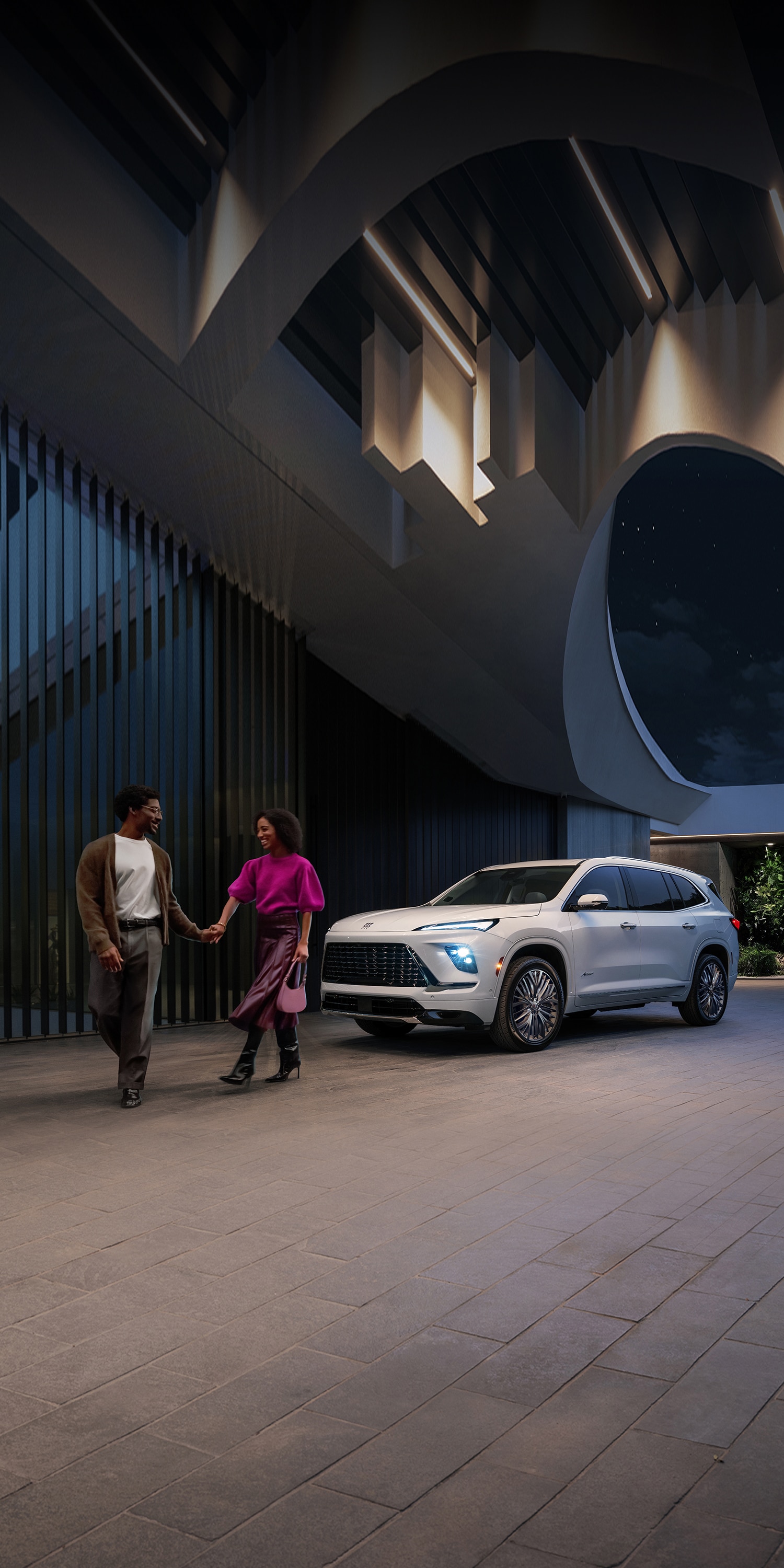 A Couple Holding Hands and Walking Away From a White Buick Enclave SUV Parked Outside