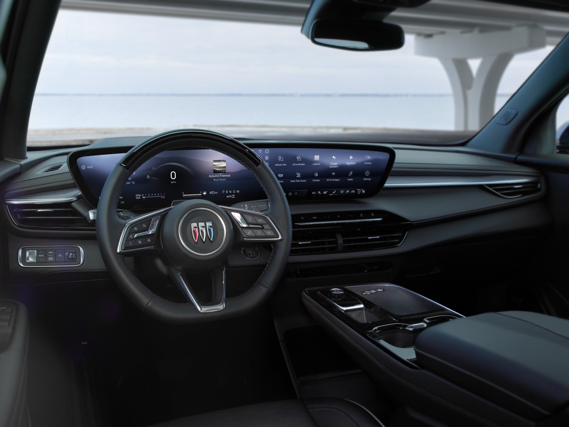 The Full Interior Dashboard of a Buick Vehicle with a Steering Wheel and a Large Curved Digital Display