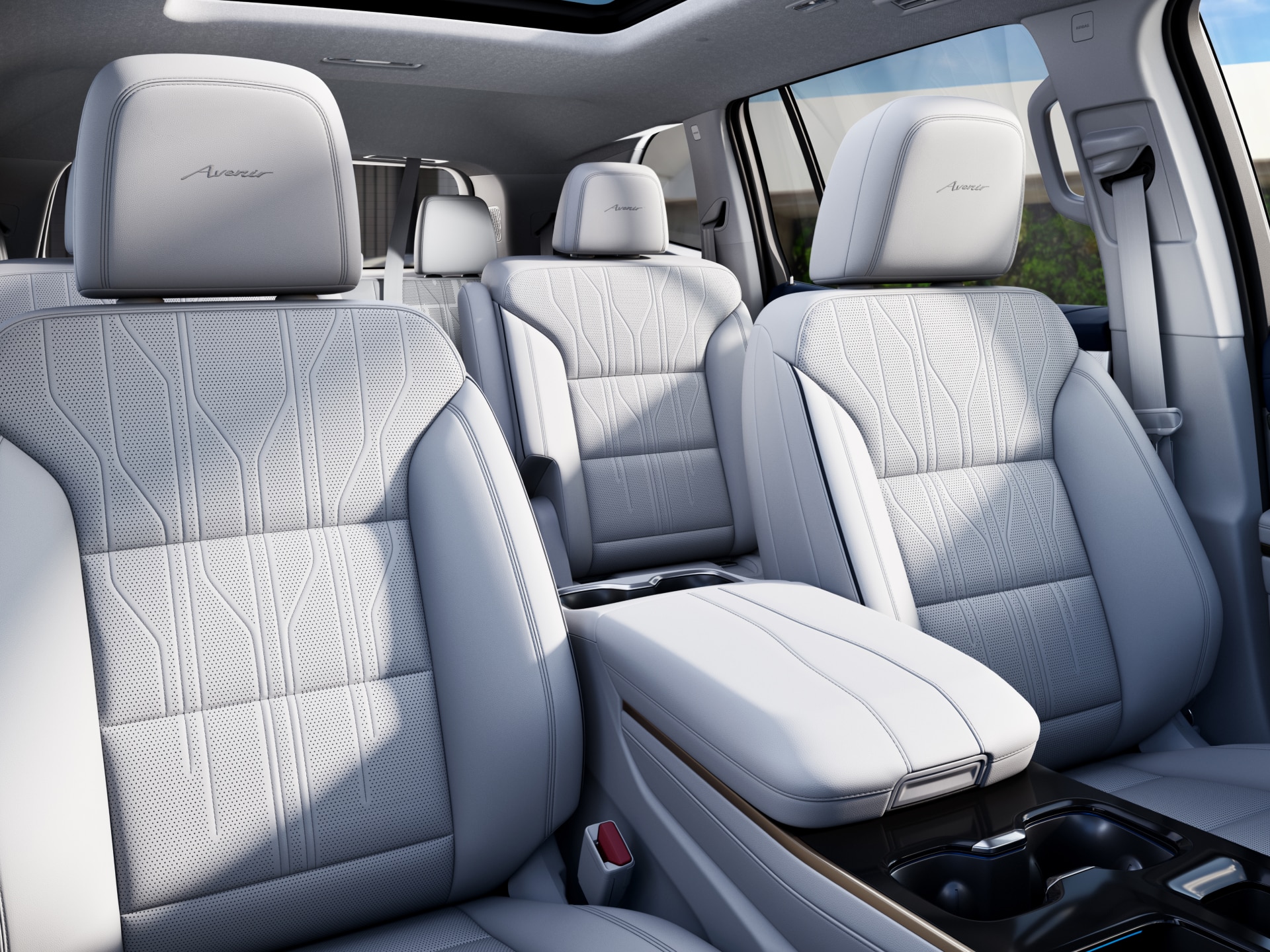 The Interior of a Buick Vehicle with Light-Colored Front and Second-Row Seats and a Sunroof