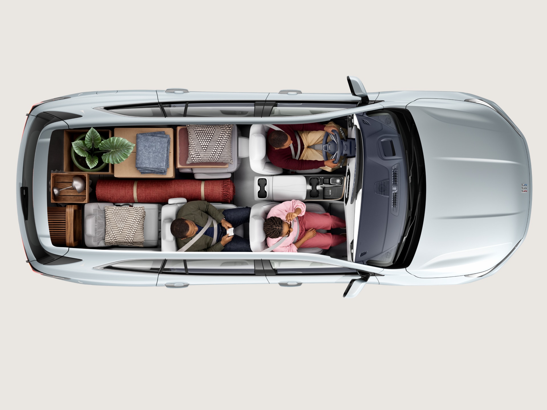 Overhead View of a White Buick SUV Interior with Four People and Various Cargo Items in the Trunk Space