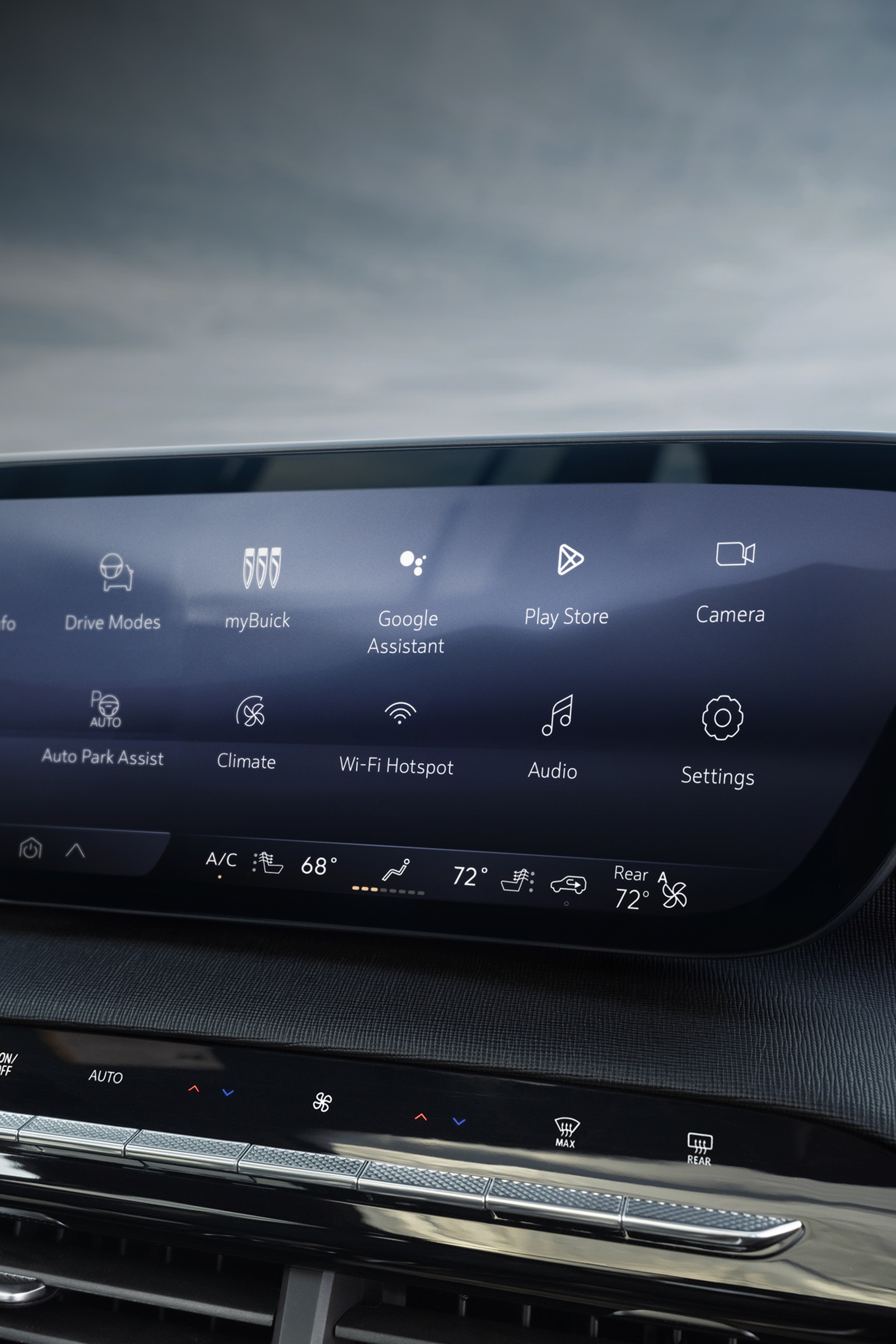 The Interior Dashboard of a Buick Car Featuring a Large Curved Infotainment Screen with App Icons