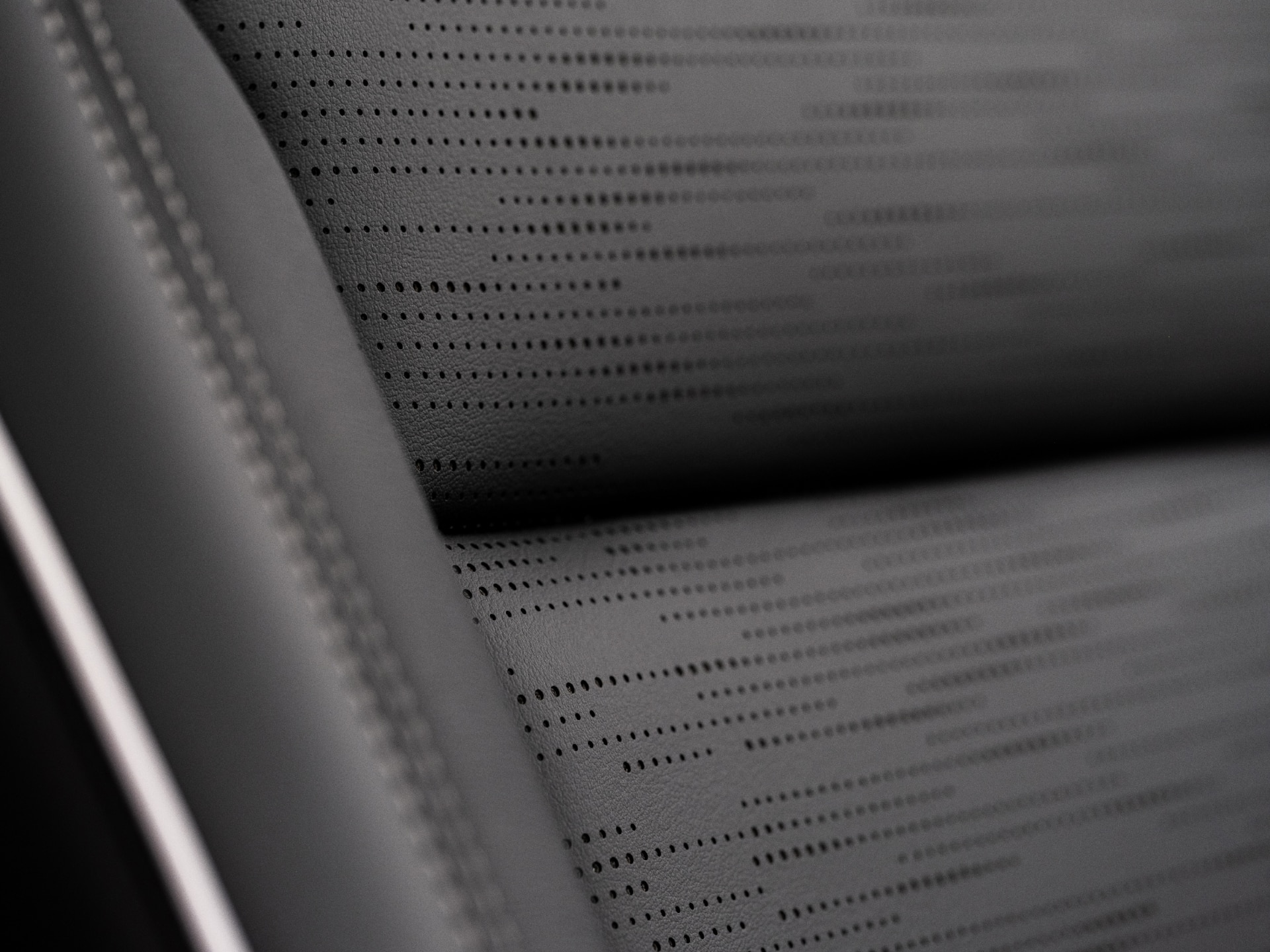 A Close-Up of a Perforated Dark Gray Buick Car Seat with Stitching Details