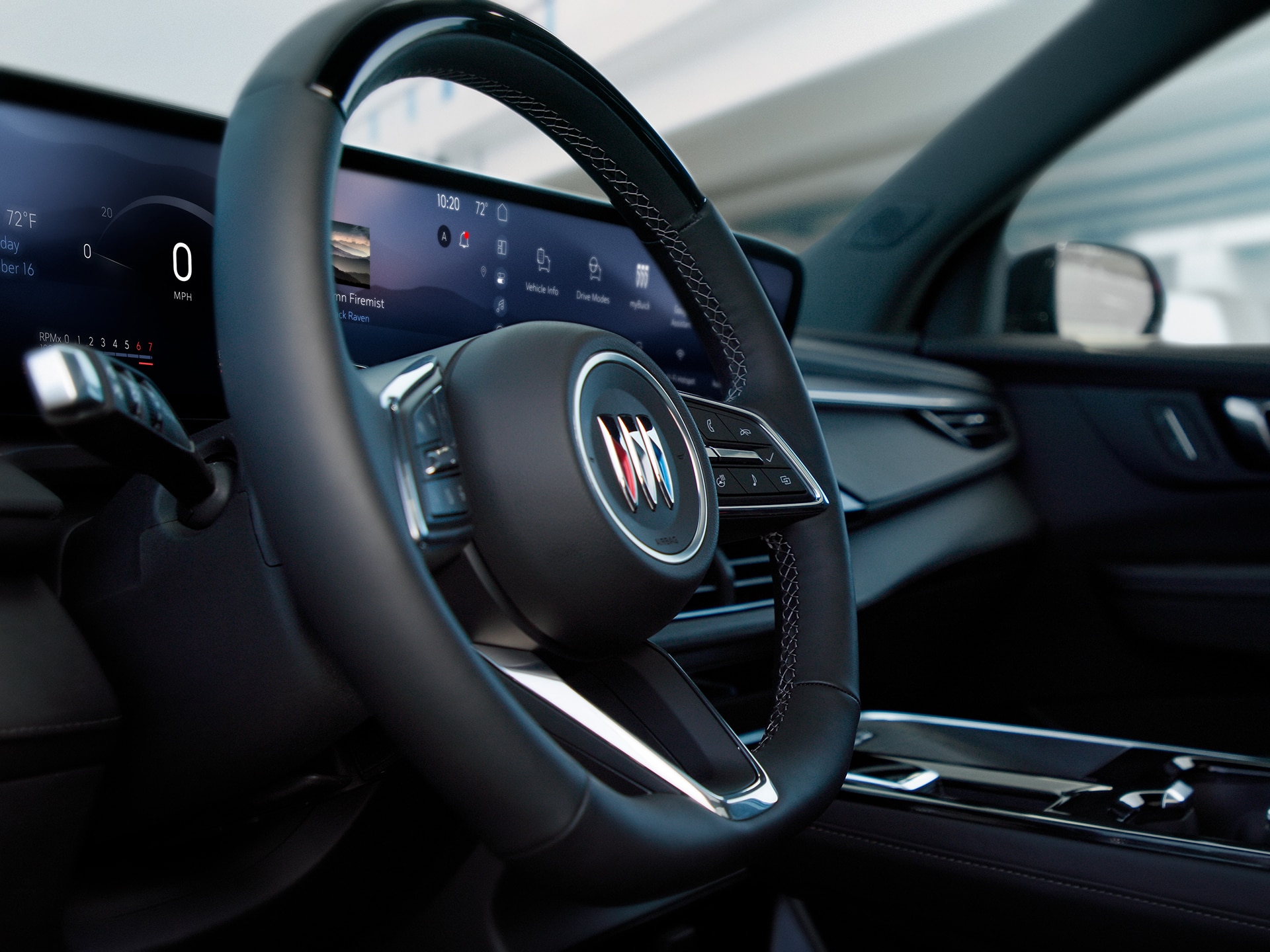 The Interior View of a Buick Car with a Steering Wheel and a Wide Digital Dashboard Near a Beach