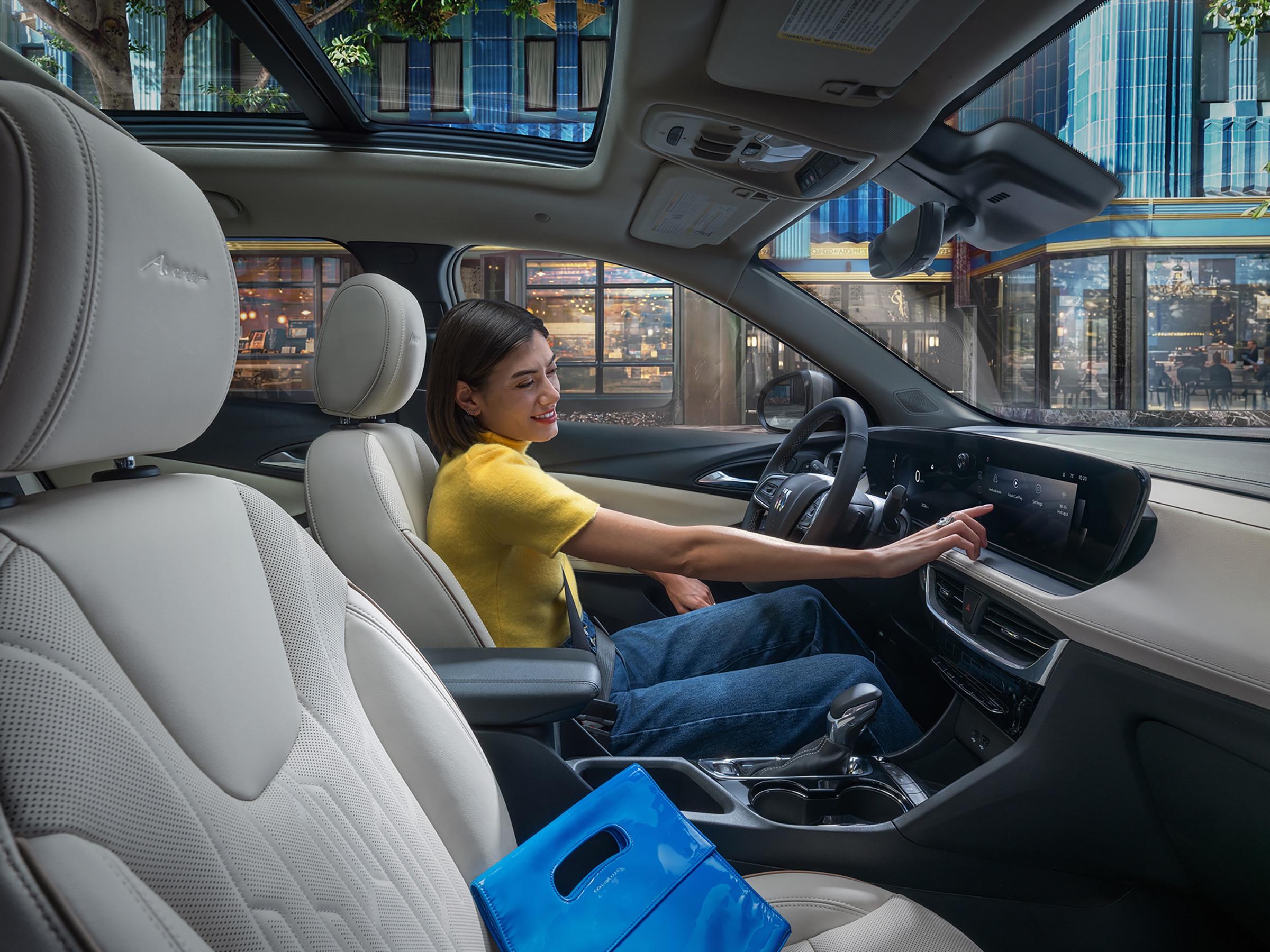 Image of a Woman Using the Infotainment Center in the 2026 Buick Encore GX