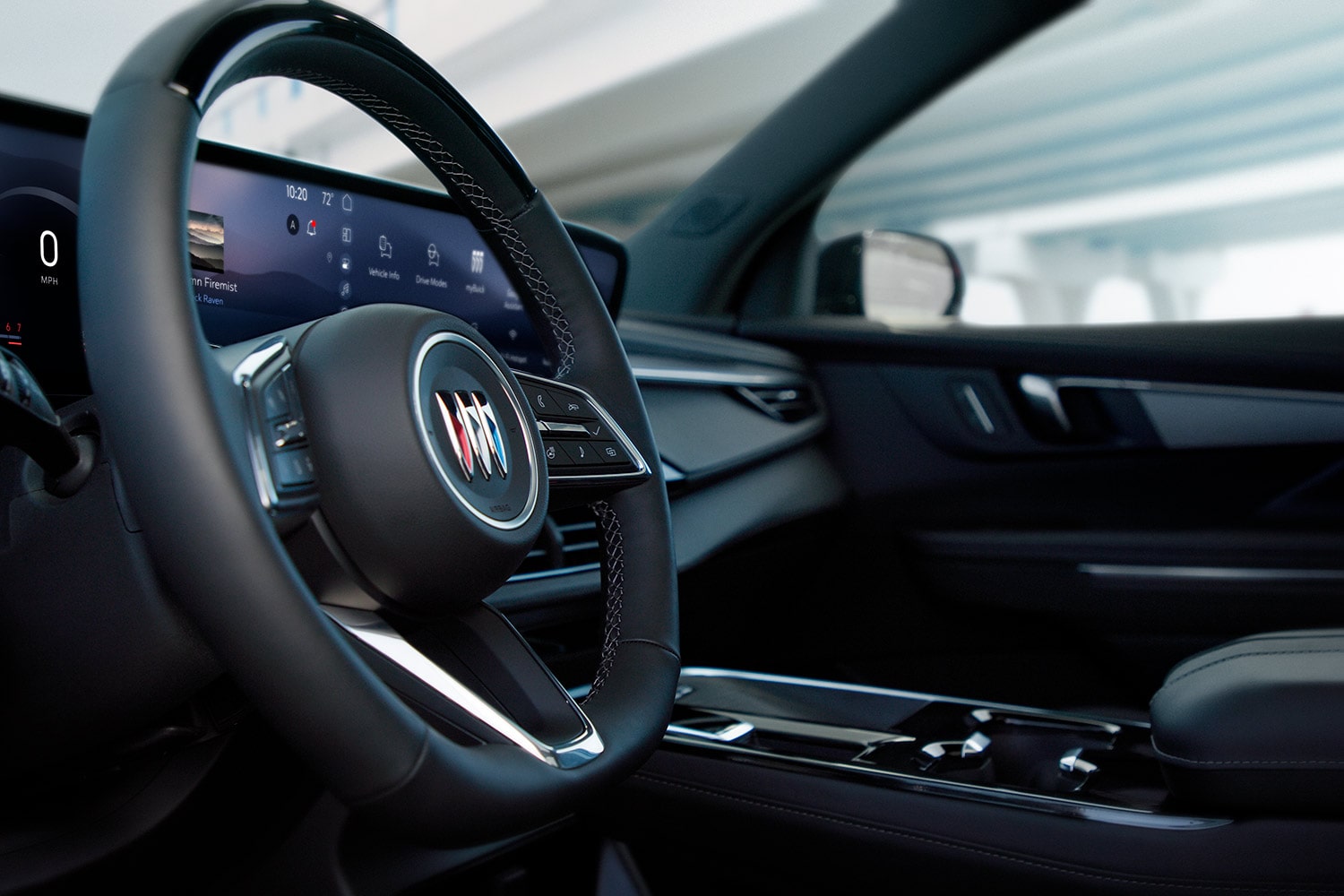 A Buick Steering Wheel with an Infotainment Screen and the General Motors Logo Overlaid