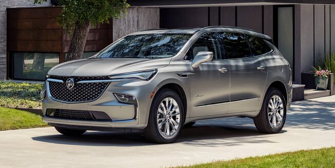 A Buick Enclave Parked in a Driveway Next to a House