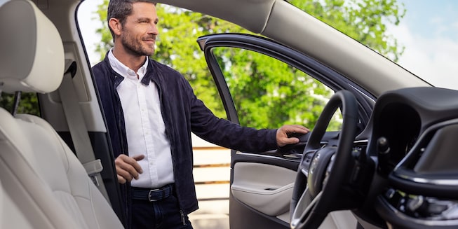 A Man Opening the Driver's Side Door on His Buick Enclave