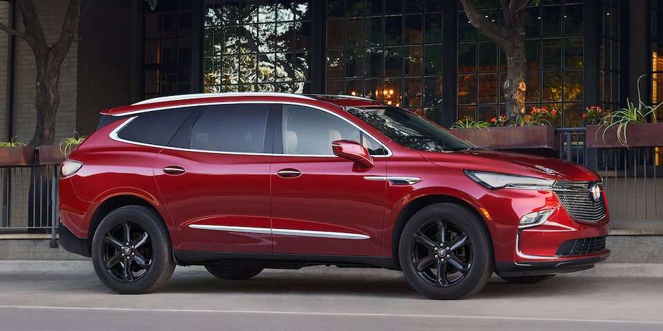 The All Red Buick Enclave Parked On Road by a Business
