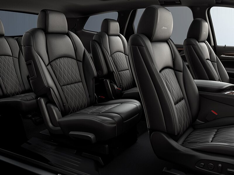 A Man Clutches the Steering Wheel of his Buick Enclave & Smiles in Satisfaction