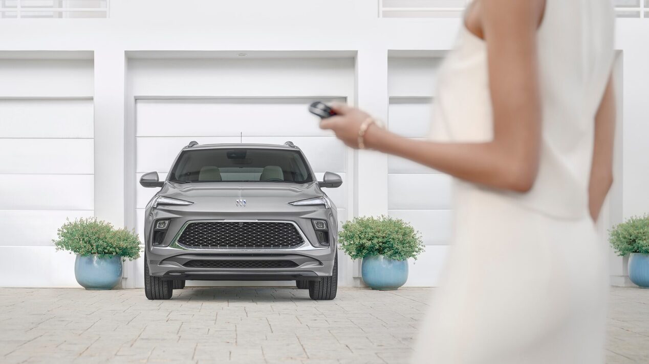Woman walking toward her parked Encore GX