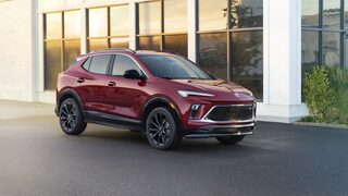 Profile View Of The 2024 Buick Encore GX ST Parked In Front Of Building
