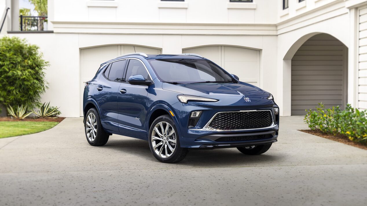 2024 dark blue Avenir Buick SUV parked in front of modern home