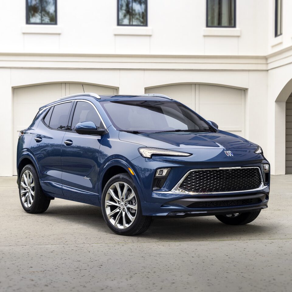 The Buick Encore Avenir Parked in Front of a Luxurious Home