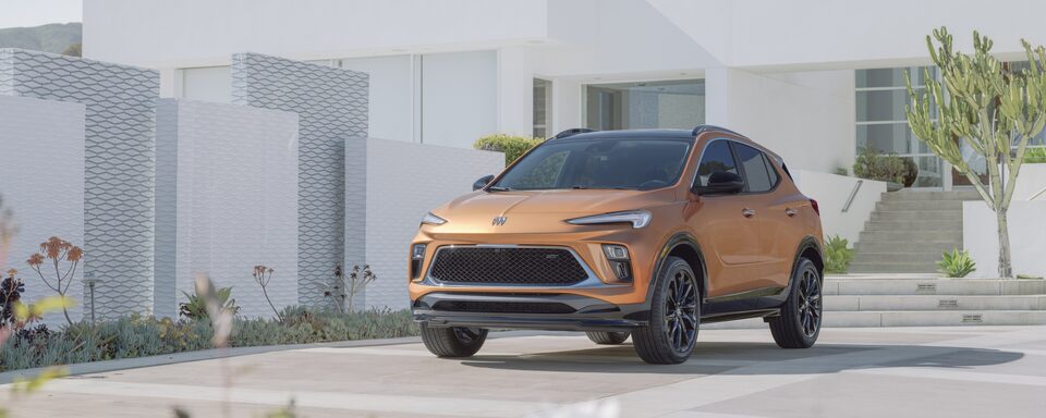 The 2024 Buick Encore GX ST Parked In Driveway Of Modern Home
