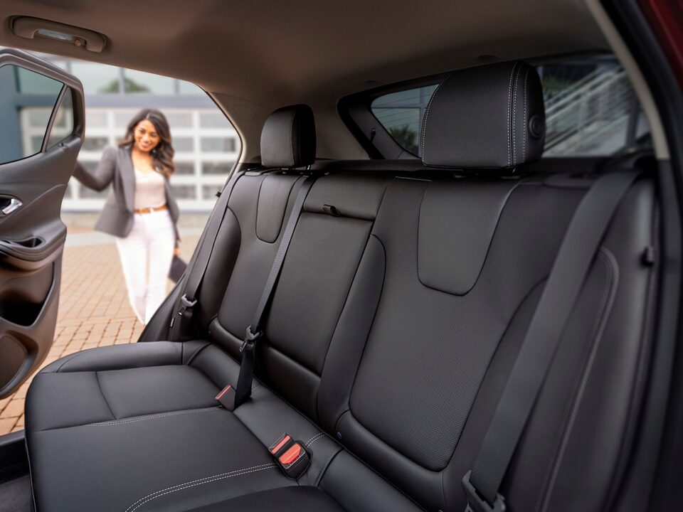 A Woman Opening the Rear Passenger Door on the Buick Encore GX ST