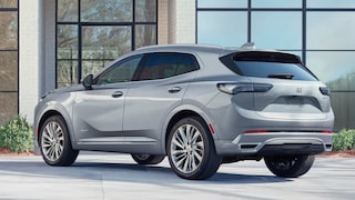 Rear Three-Quarters View of 2024 Buick Envision Parked in Front of a Building