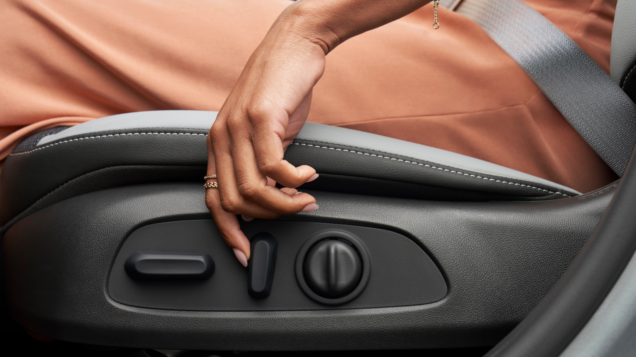 Woman in the Seat of the 2024 Buick Envista Using the Side Seat Controls