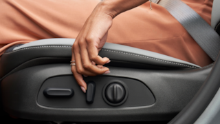 Woman in the Seat of the 2024 Buick Envista Using the Side Seat Controls