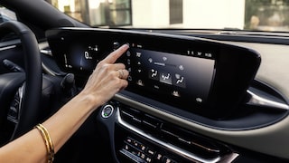 A Woman Clicking the Infotainment System in the Buick Envista