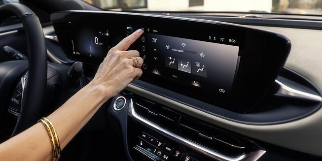 A Woman Clicking the Infotainment System in the Buick Envista