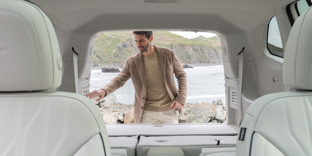 A Man Standing Next to an Open Trunk of a 2025 Buick Enclave