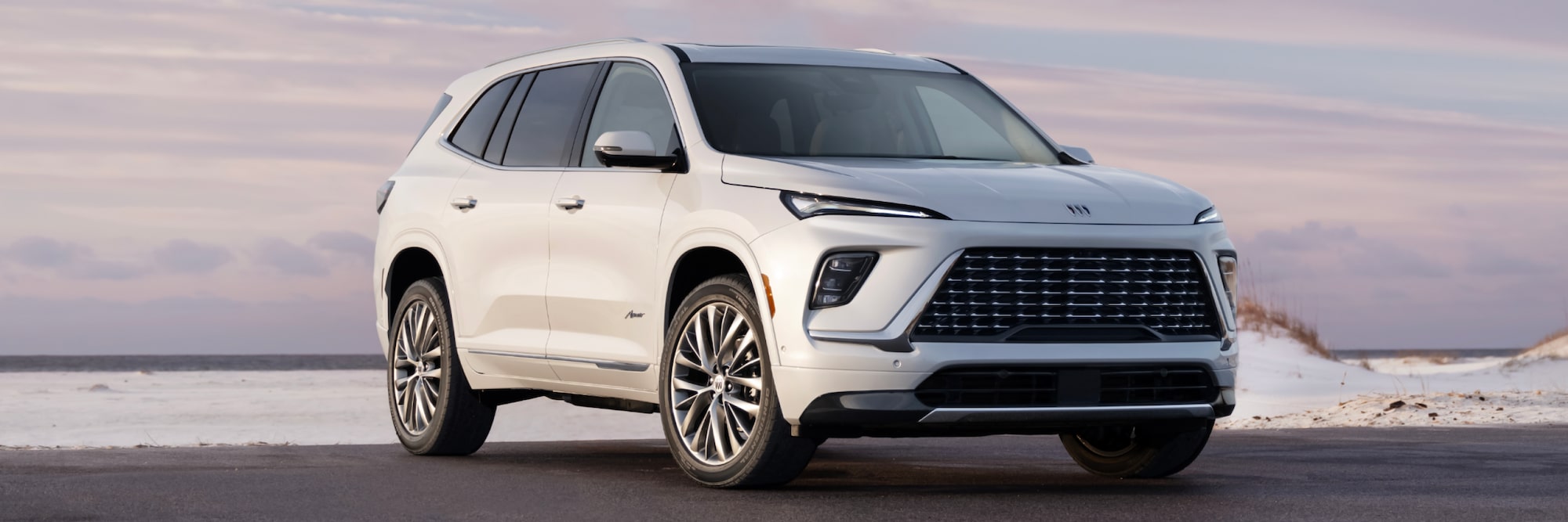 2025 Buick Enclave parked in front of beach.