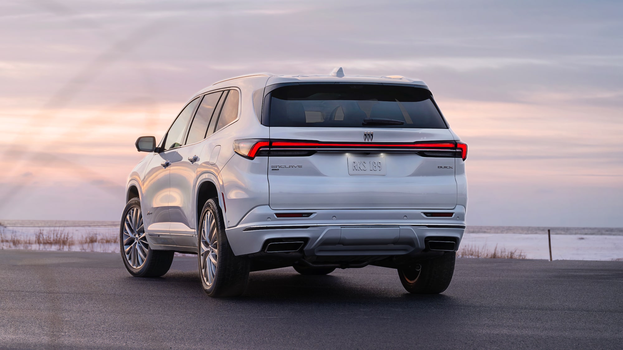 2025 Buick Enclave Avenir parked in front of beach landscape.