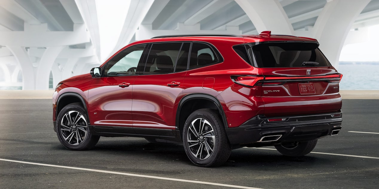 Three-Quarters Rear View of a Red 2025 Buick Enclave ST Under a Bridge