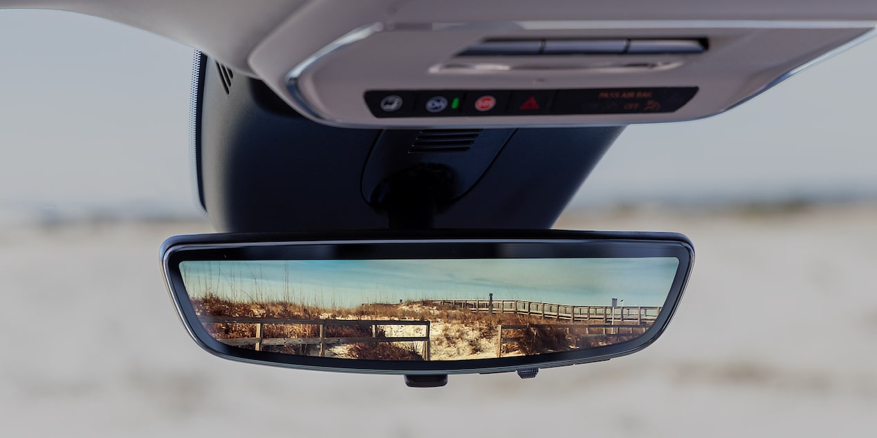 Close-up of the Rear View Mirror in a 2025 Buick Enclave Reflecting an Image of a Desert