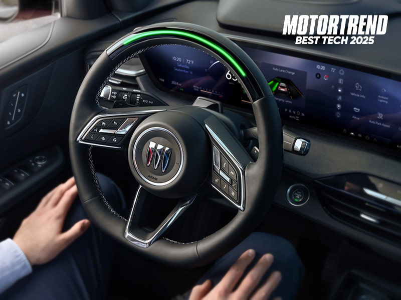 Driver Using Super Cruise Hands Free Driving Technology in Their Buick Enclave with MotorTrend Logo
