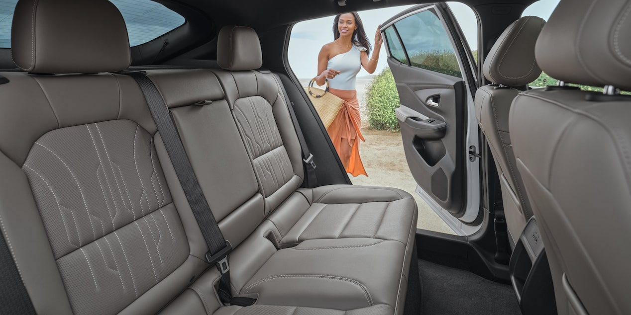 A Woman Opening the Back of the 2025 Buick Envista Viewing the Split-folding Rear Seats