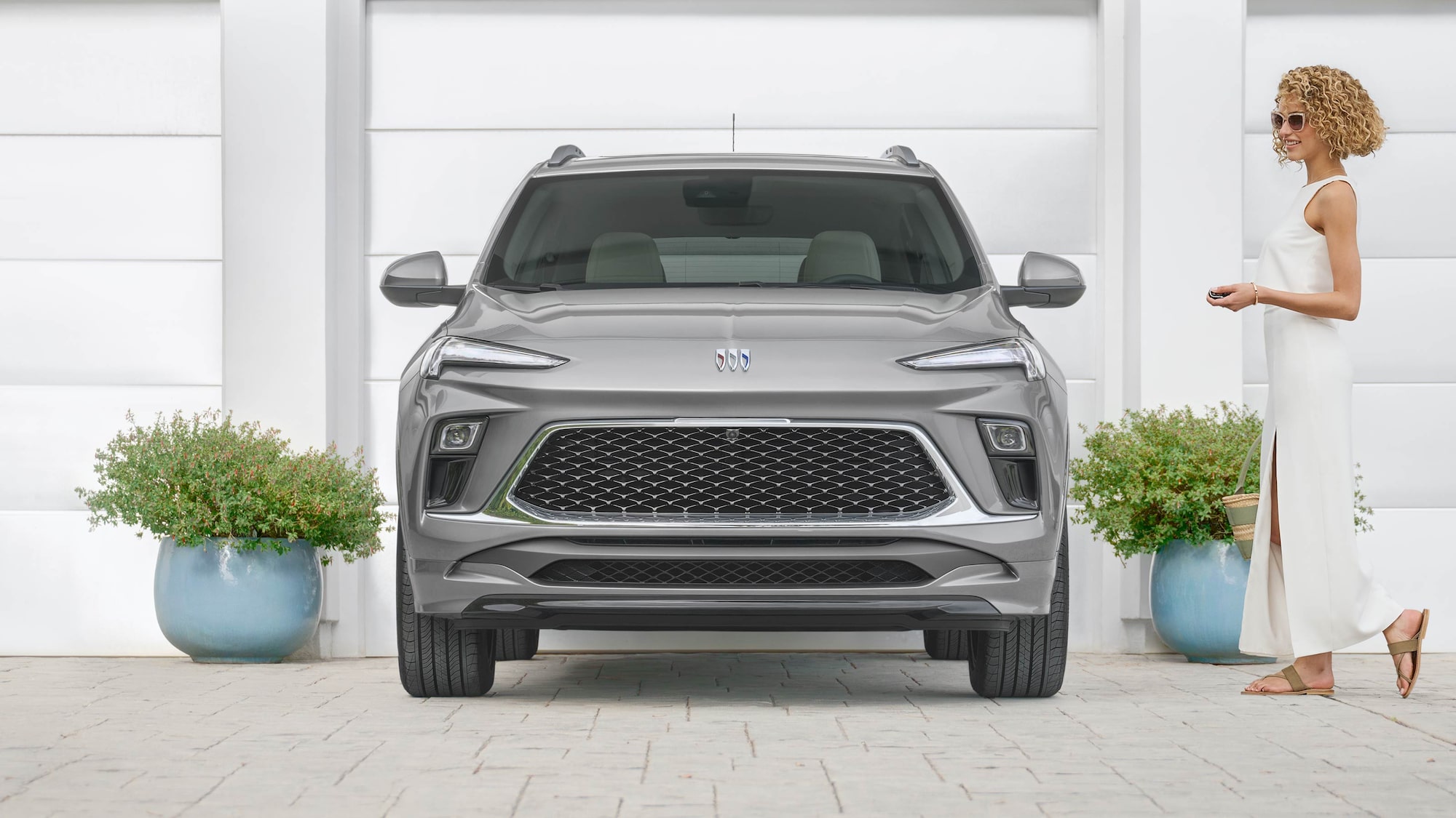 Navy 2025 Buick Encore GX Avenir parked on street 