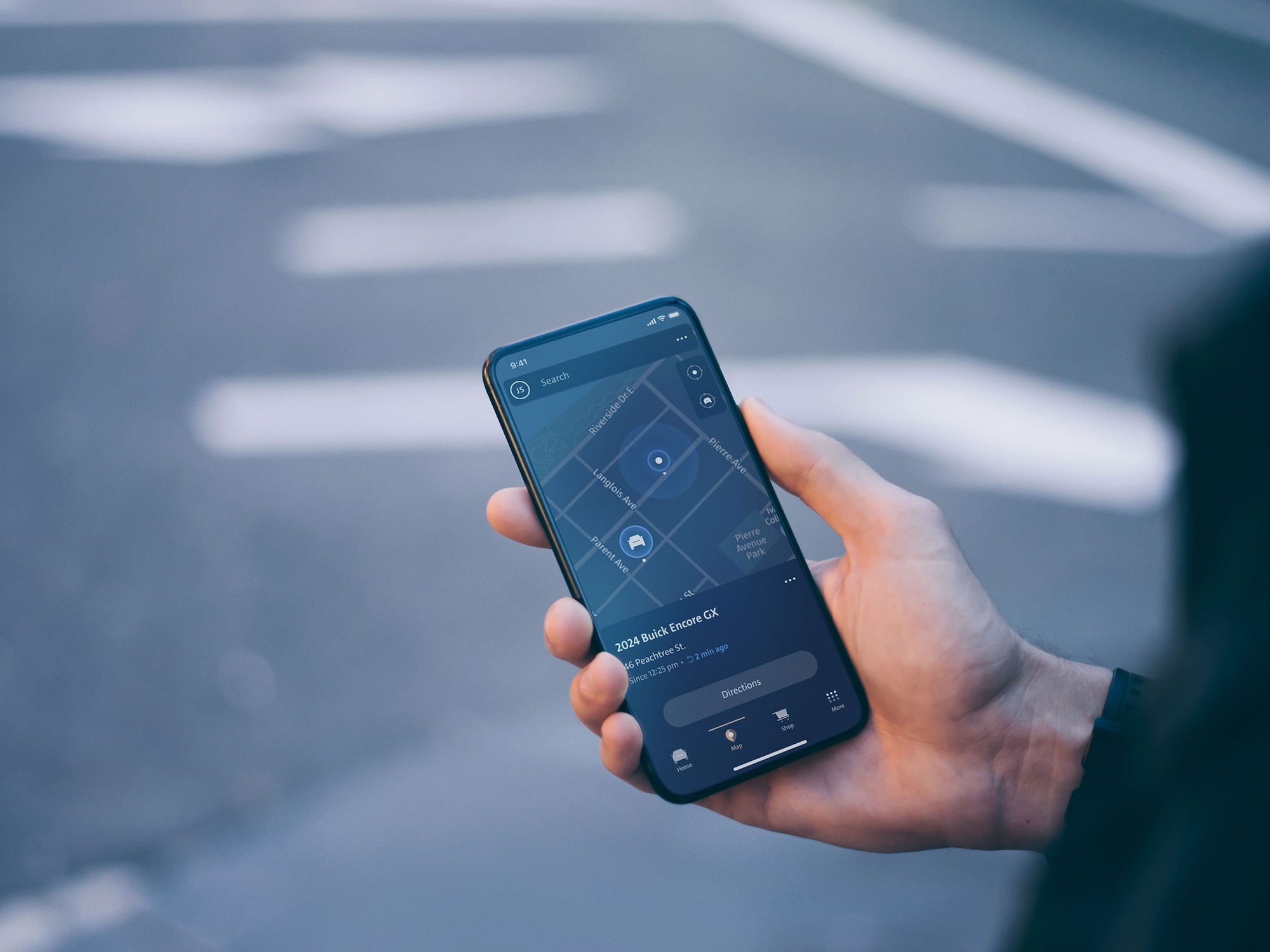 Customer Holding Their Smartphone Displaying the Buick Remote Commands App