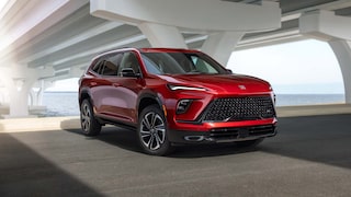Three Quarters View of a 2026 Red Buick Enclave Parked under a Bridge