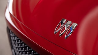 Close-up of a 2026 Red Buick Enclave Front Hood with Focusing on the Emblem