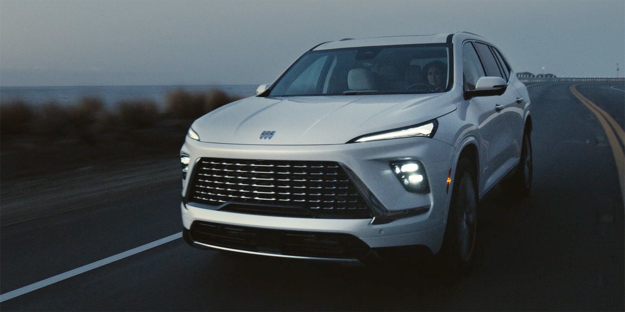 Close-up of a 2026 White Buick Enclave Front Hood with a Focus on the Front Headlight