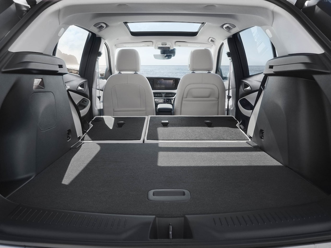 Interior View From the Rear of the Buick 2026 Encore GX Avenir Luxury SUV with the Rear Seats Folded Down