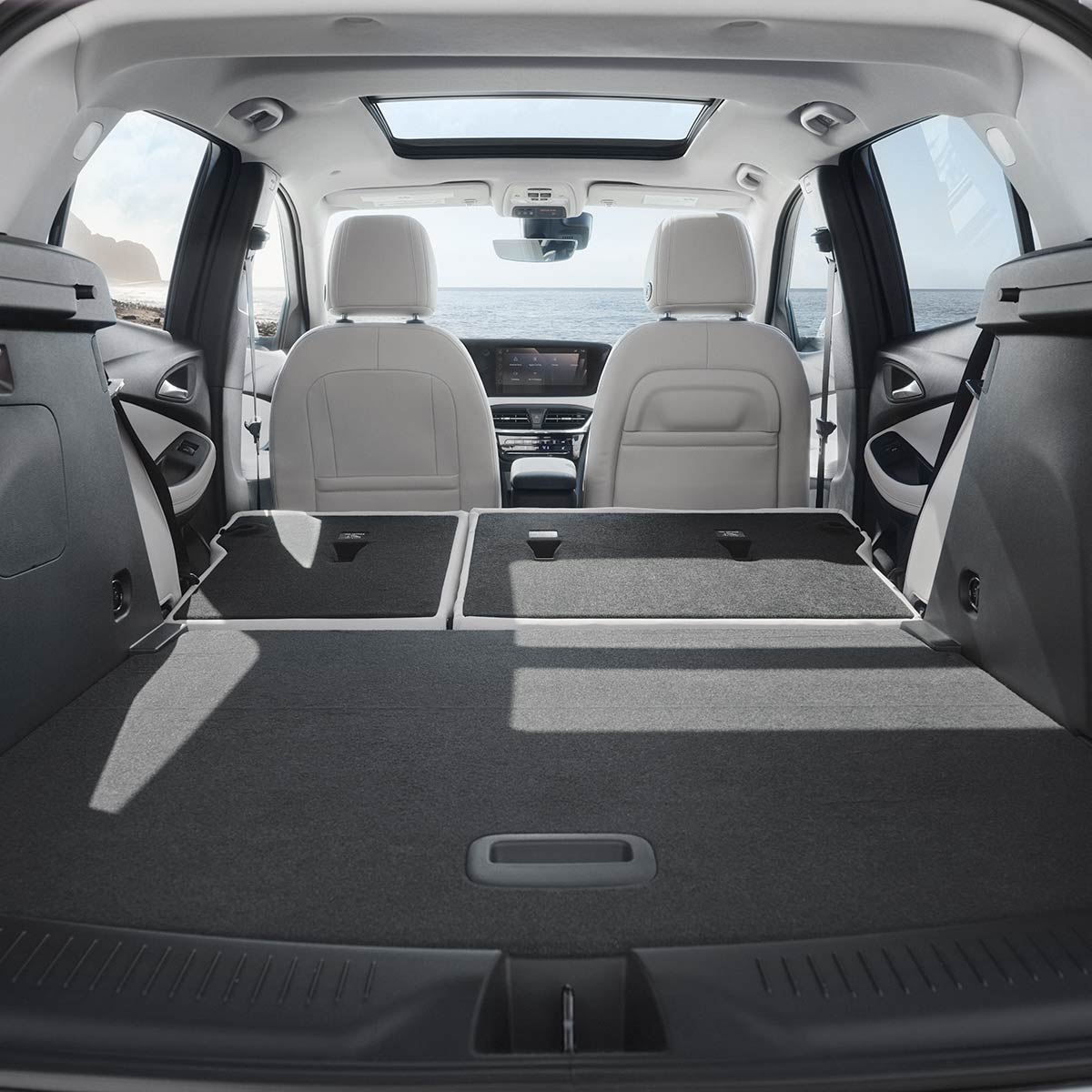 Interior View From the Rear of the Buick 2026 Encore GX Avenir Luxury SUV with the Rear Seats Folded Down