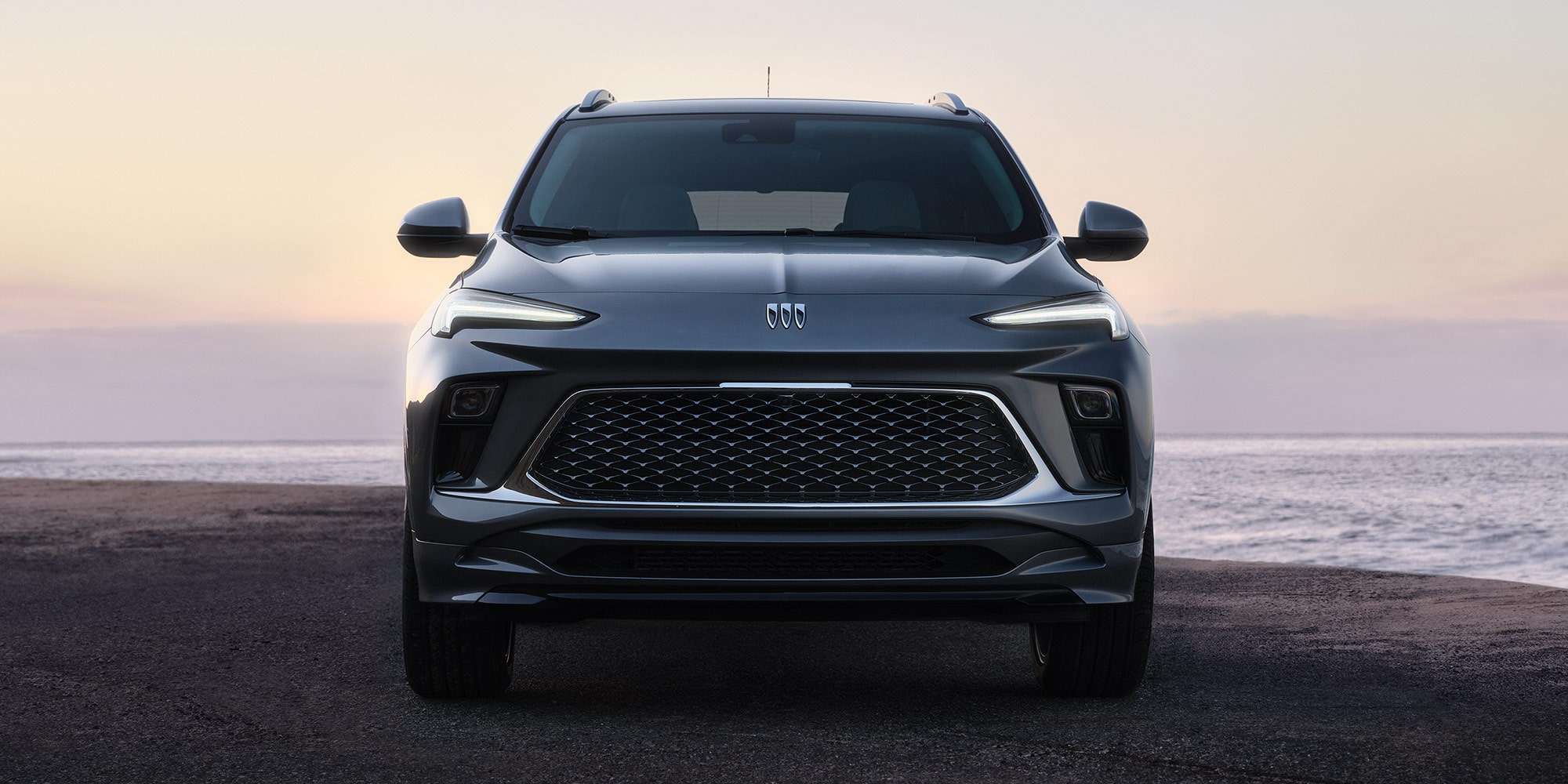Front View of the 2026 Buick Encore GX Small SUV Parked on the Beach at Sunset