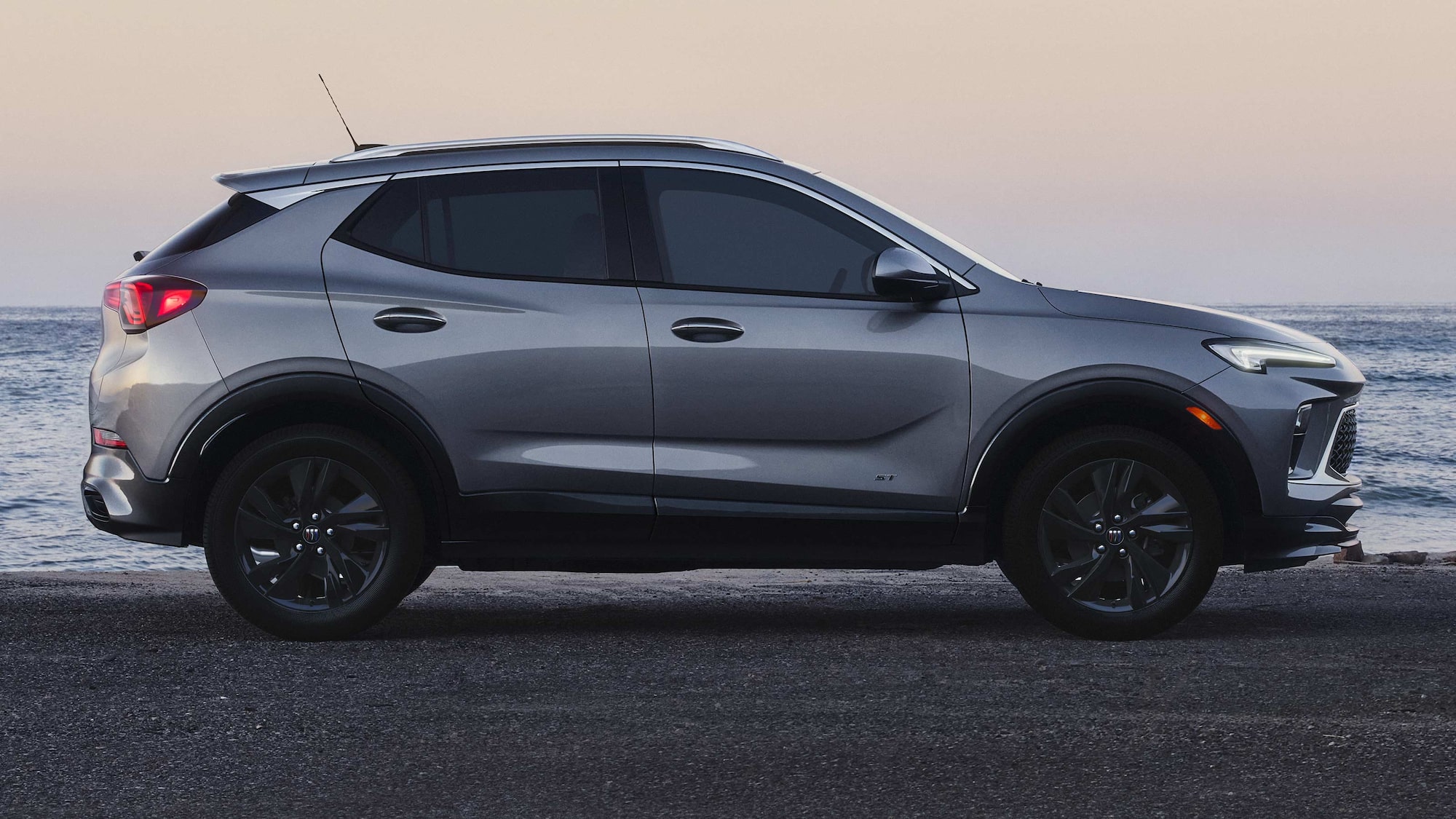 Profile View of the 2026 Buick Encore GX ST Luxury SUV Parked on the Beach at Sunset