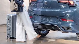 A Woman Using Her Foot to Activate the Buick 2026 Encore GX Power Liftgate