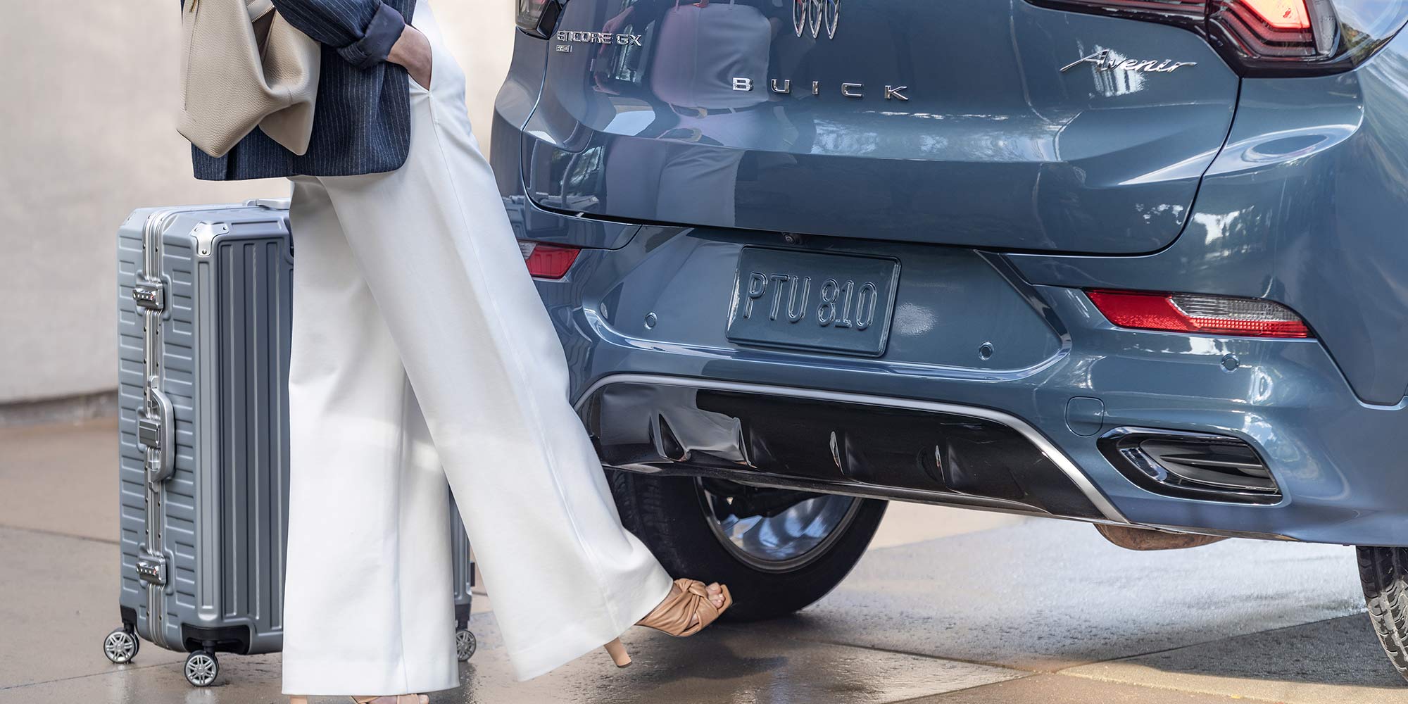 A Woman Using Her Foot to Activate the Buick 2026 Encore GX Power Liftgate