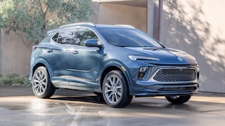 Front Three-Quarters View of the 2026 Buick Encore GX Small SUV Parked in a Driveway While the Sun Shines