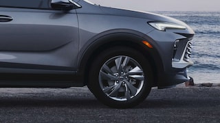 Close-up Profile View of the 2026 Buick Encore GX Avenir Luxury SUV Parked on the Beach at Sunset