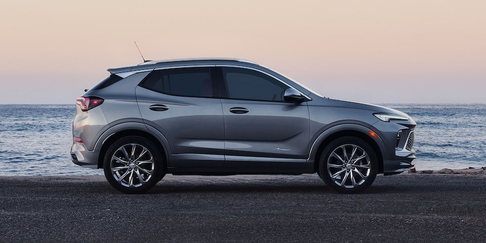 Profile View of the 2026 Buick Encore GX Avenir Luxury SUV Parked on the Beach at Sunset