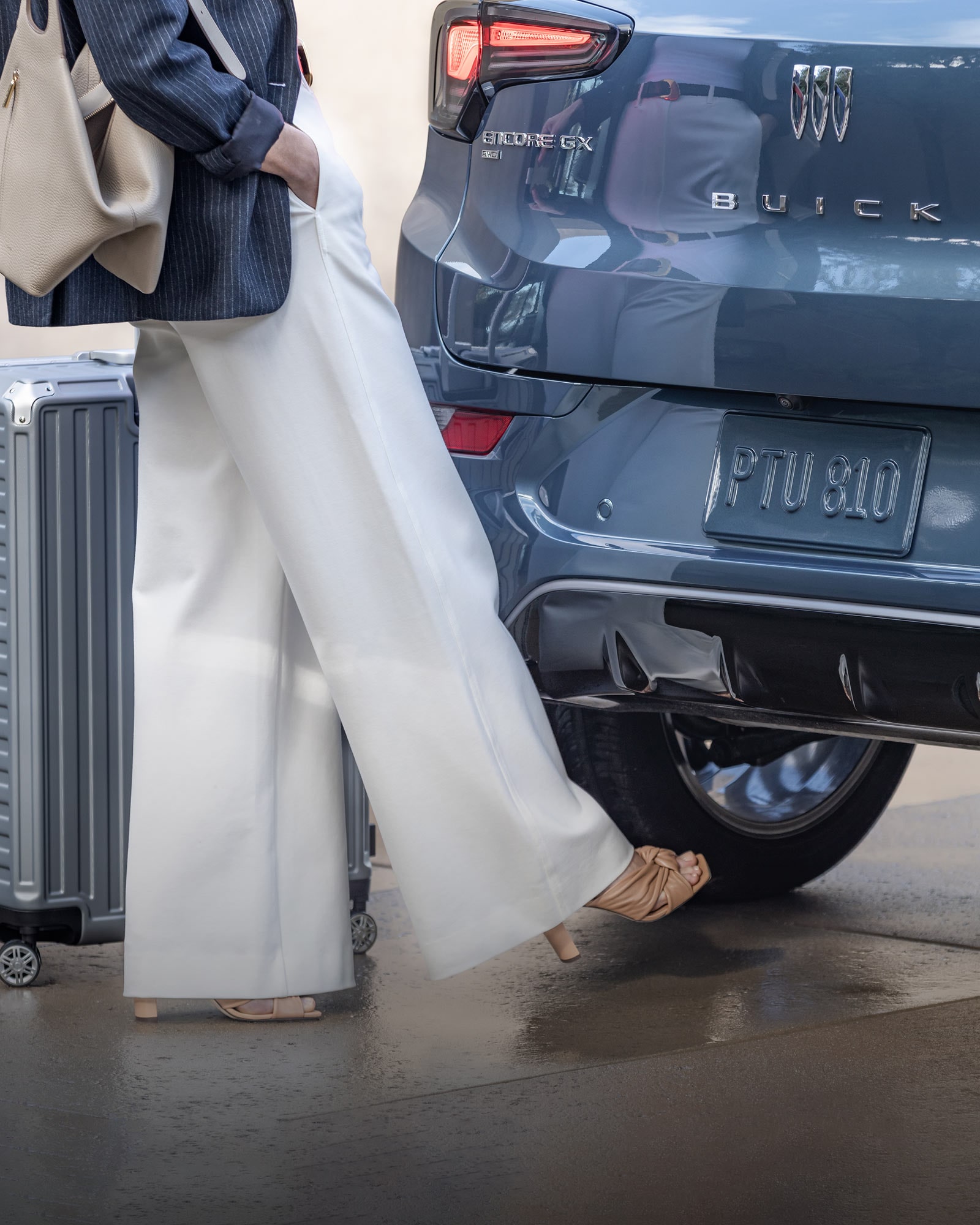 A Woman Using Her Foot to Activate the Buick 2026 Encore GX Power Liftgate