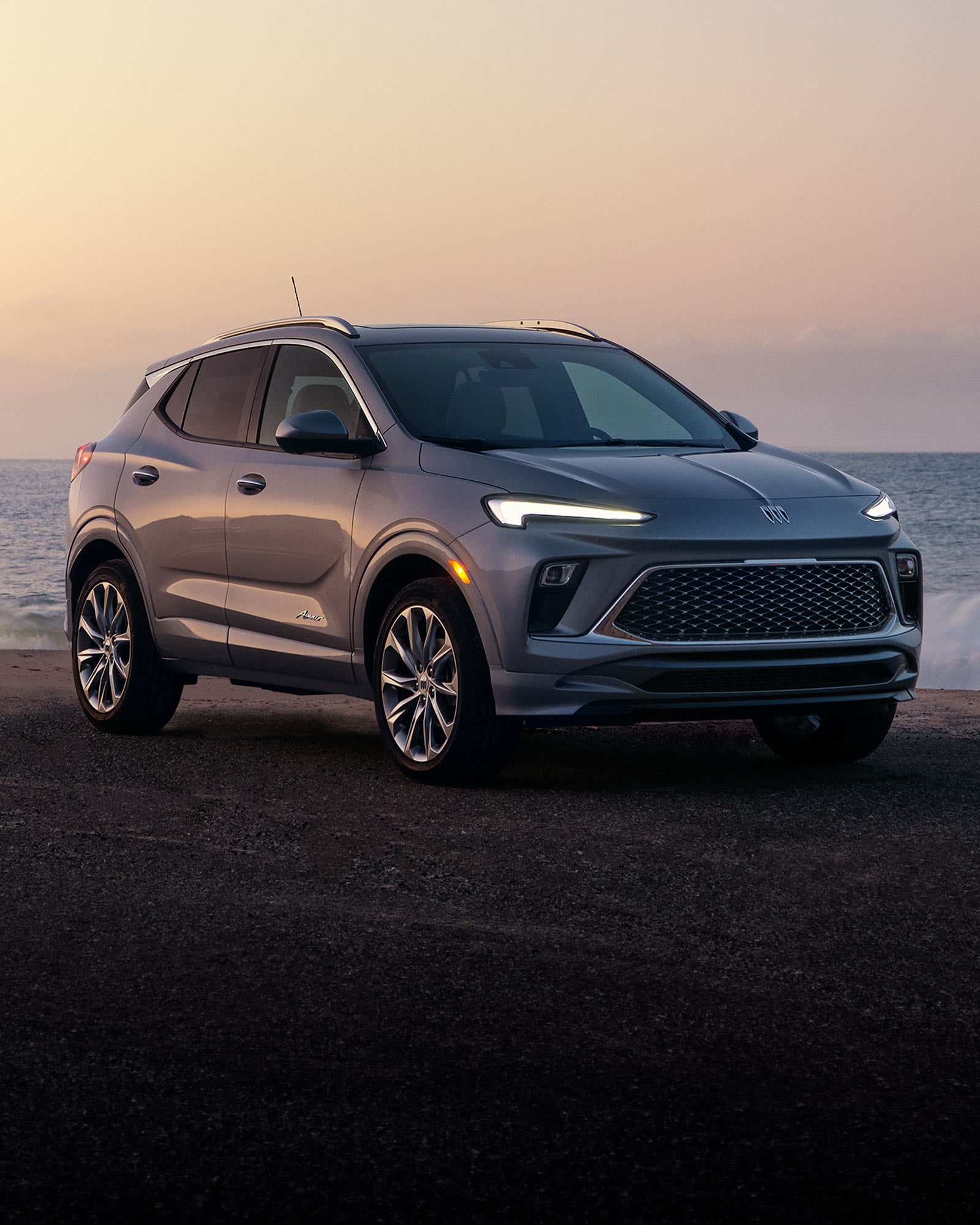 Front Three-Quarters View of the 2026 Buick Encore GX Parked on the Beach at Sunset