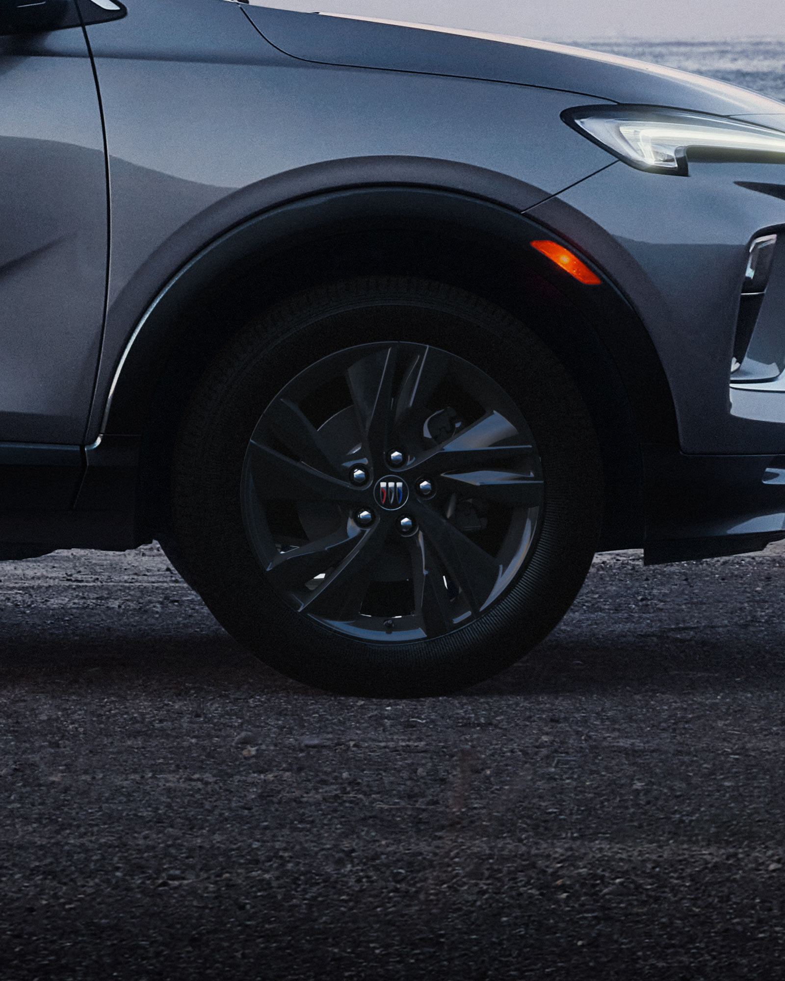 Exterior Profile View of the Buick 2026 Encore GX ST Sporty SUV Parked on a Beach