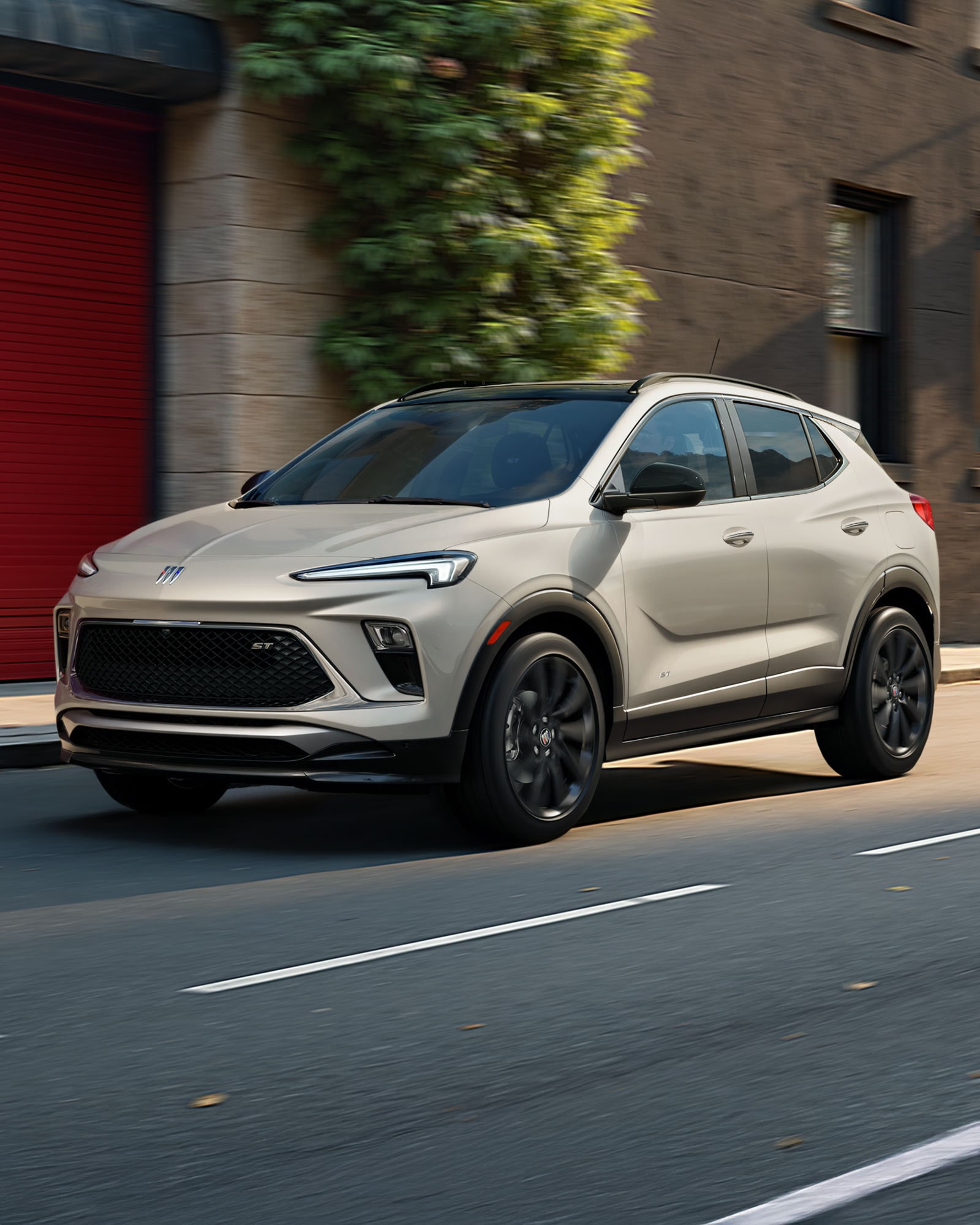 Exterior Front View of the Buick 2026 Encore GX ST Sporty SUV  Parked on a Beach at Sunset
